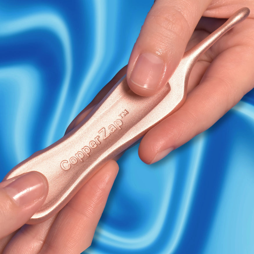 Hands holding a copper tool labeled 'CopperZap' against a blue background.